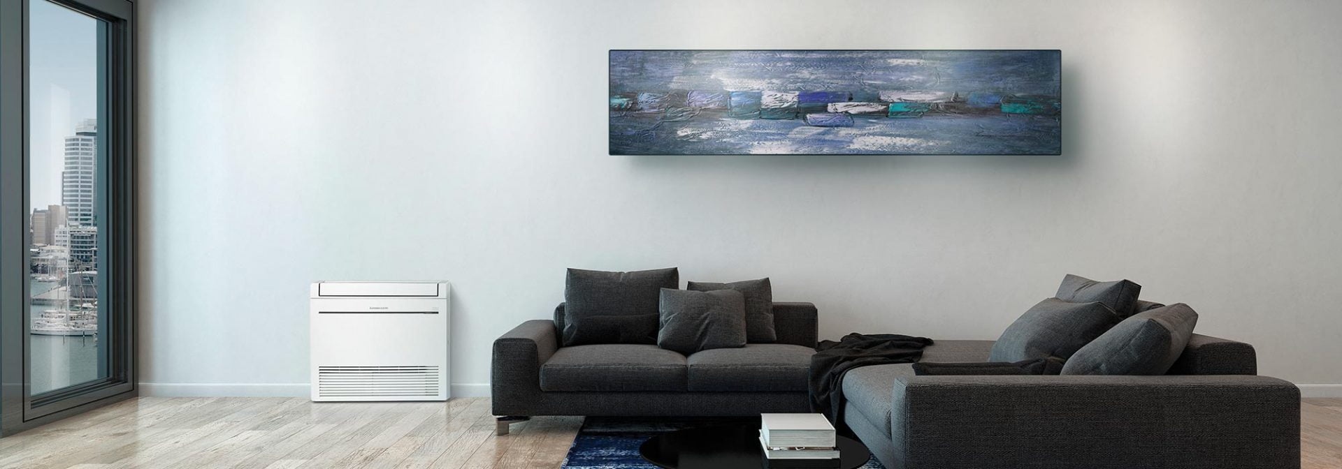 Modern living room with blue walls and grey couch. The room has a heat pump located on the floor