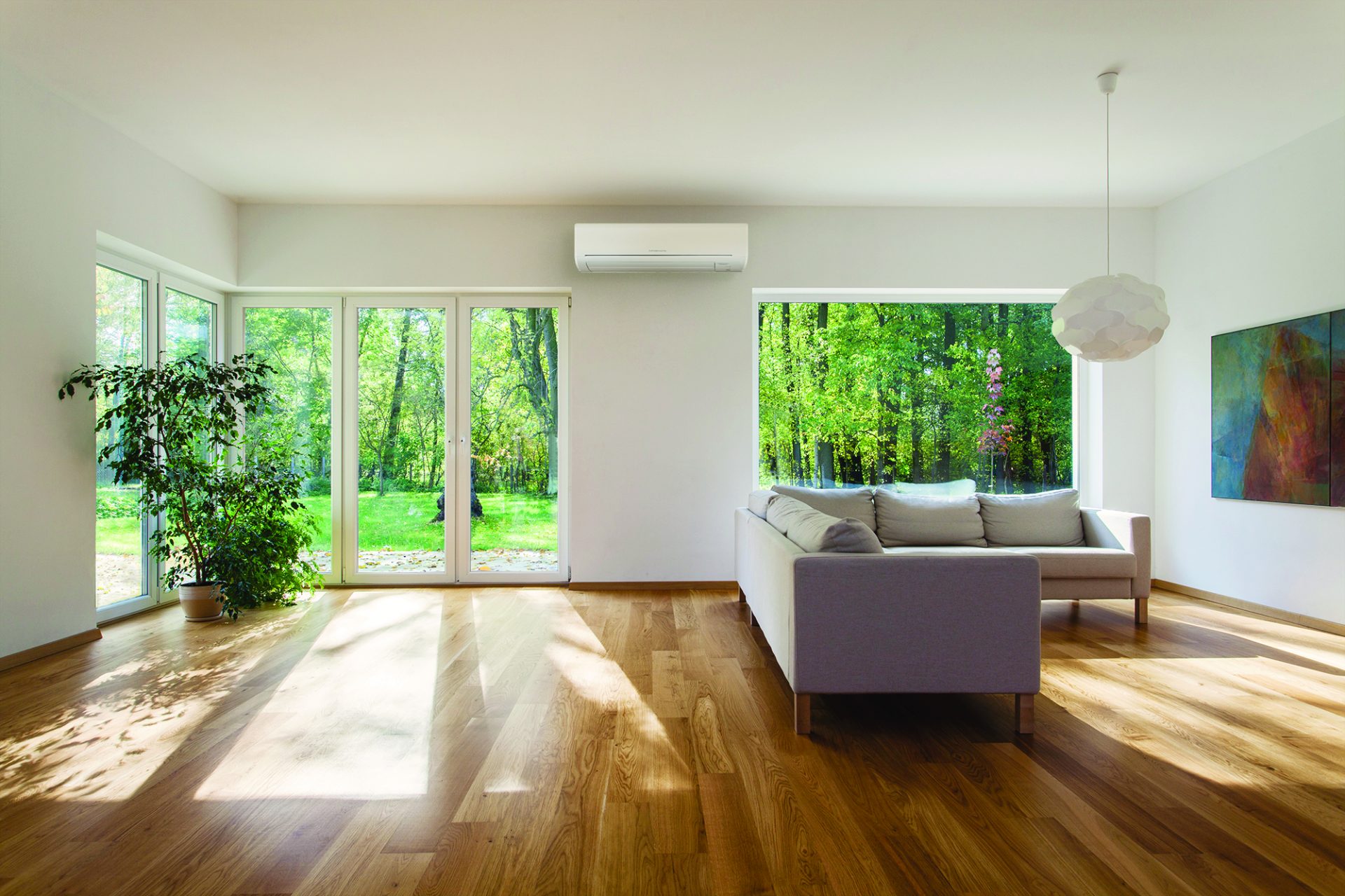 Lounge with a heat pump mounted on the wall. The room has wooden floors and large windows